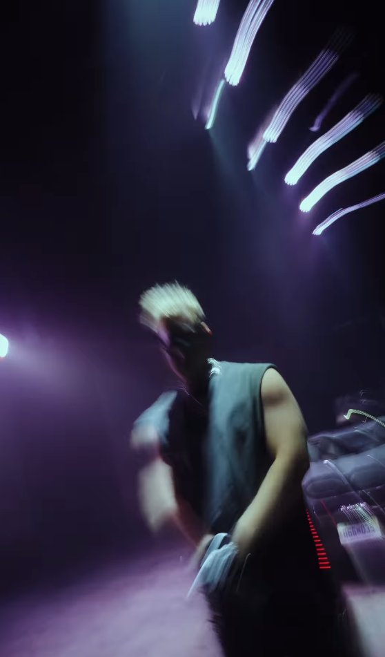 Creator in motion under purple neon lights at night